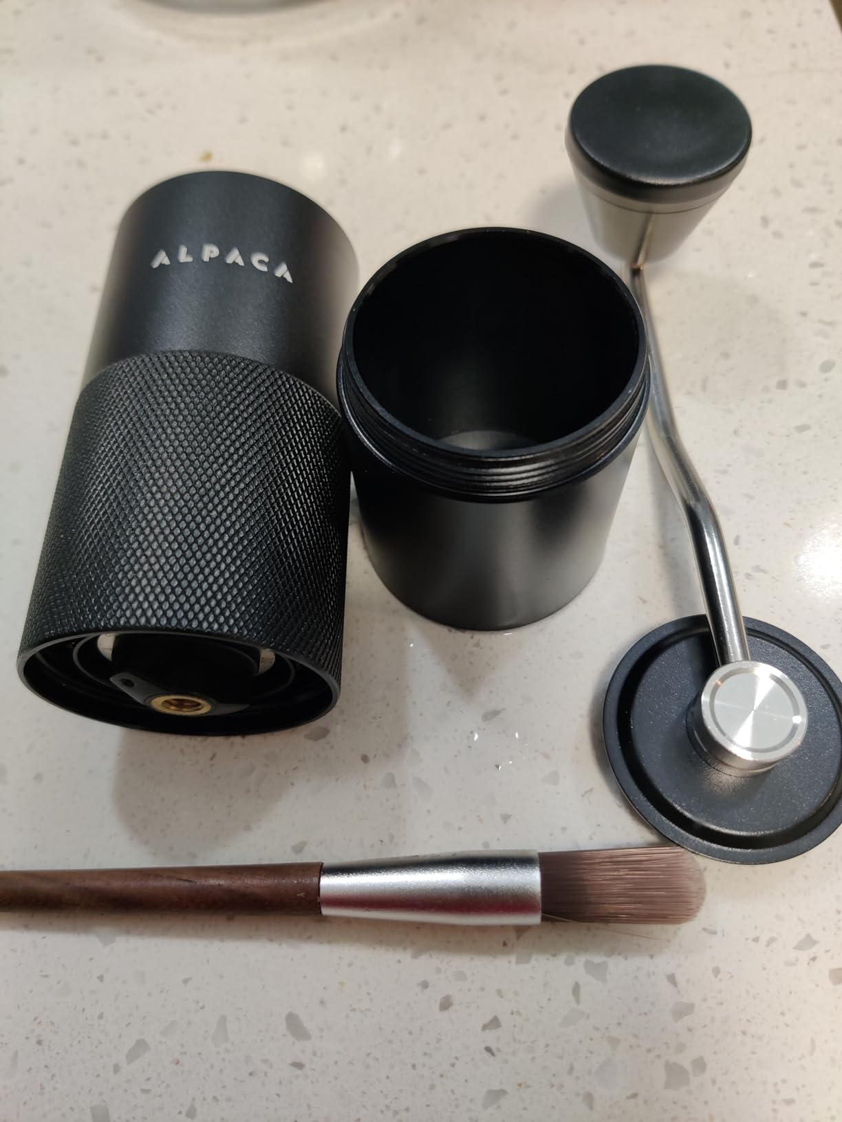 Alpaca grinder taken apart: body, aluminum catch cup, crank handle and brush